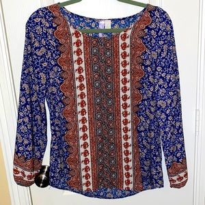 Beautiful fall blouse but still thin enough to pair with a vest or sweater.